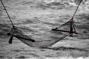 Image of string hammock suspended near water