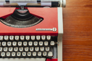 Closeup partial image of orange vintage Olympia typewriter