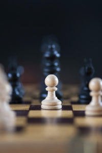 Image of chess pieces focused on white pawn