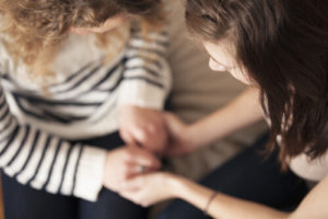 Image of two women praying together