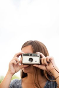 Woman taking photo with old camera