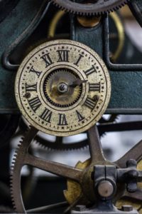 Cogs and face of old clock with Roman numerals