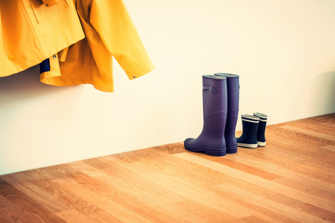 Image of gumboots and raincoats in hallway