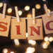 Image of the word 'Sing' pegged onto rope