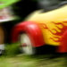 Blurred image of child's yellow and red ride-in car