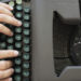 Image of hands and vintage typewriter keys