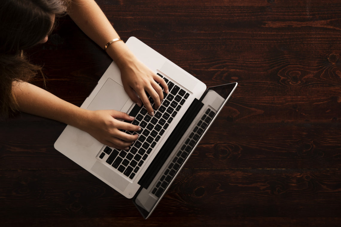 Overhead image of young woman with laptop