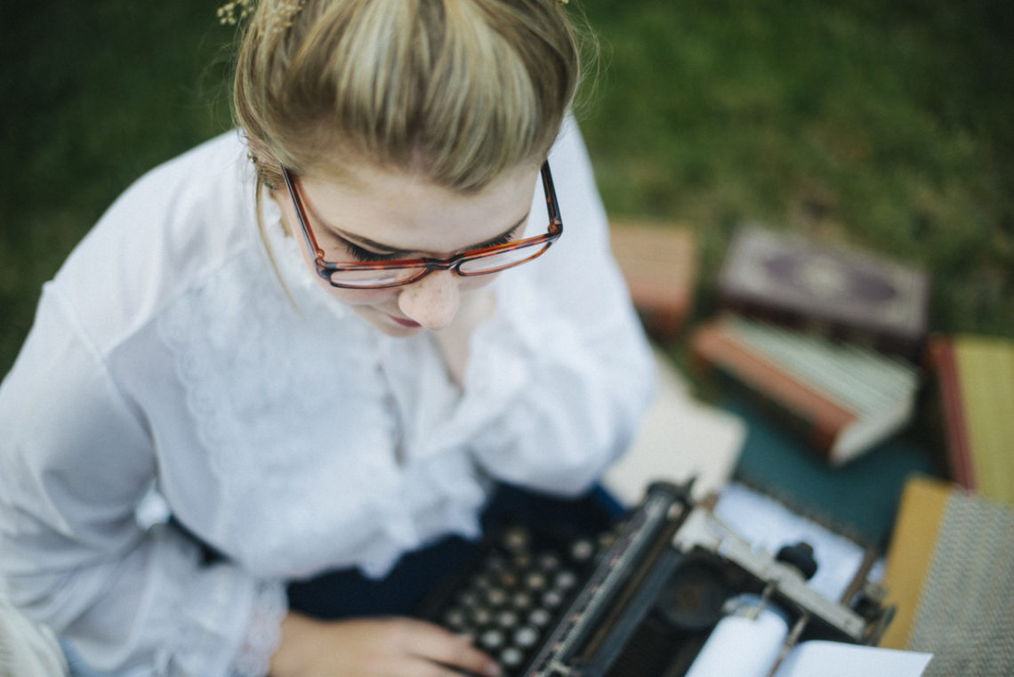 Image of young woman with old typewriter