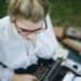 Image of young woman with old typewriter