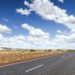 Image of road through flat dry landscape