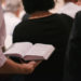 Image of man holding hymnbook