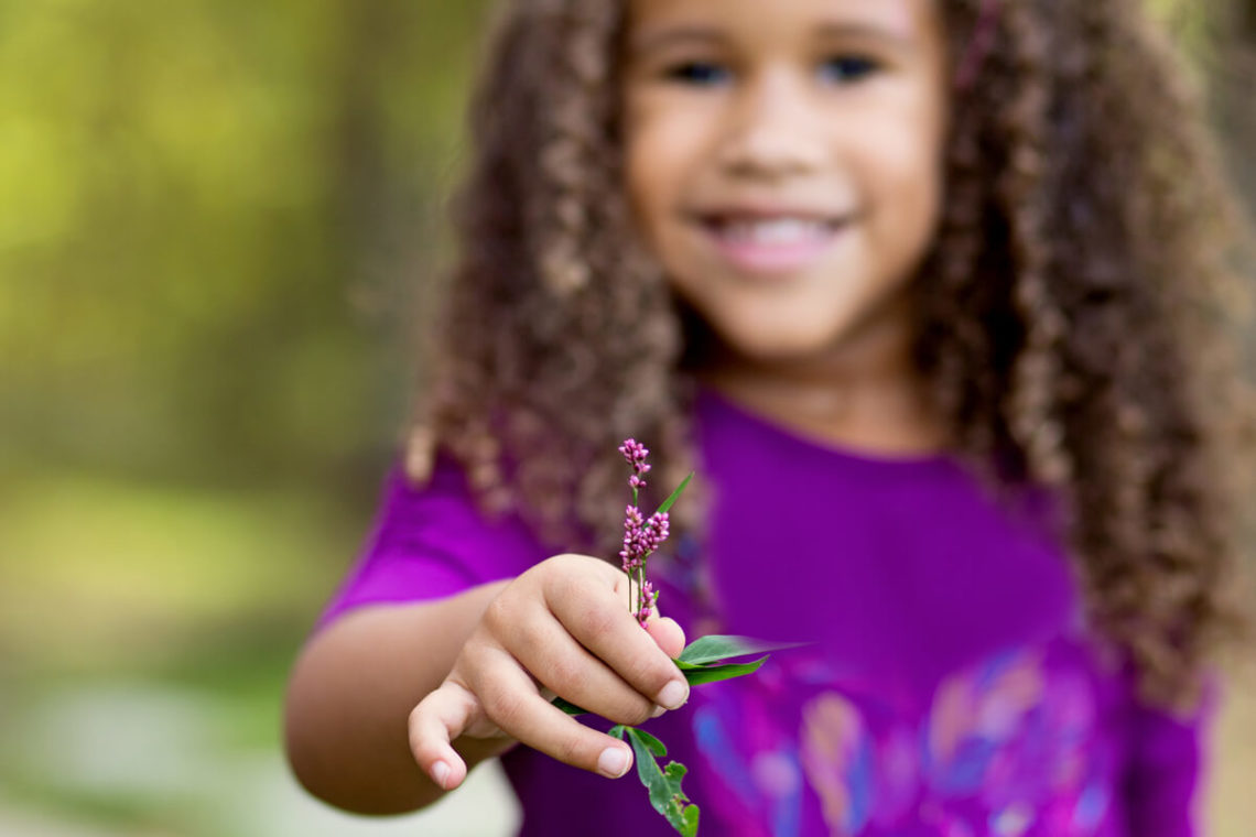 Image of girl with purple flower