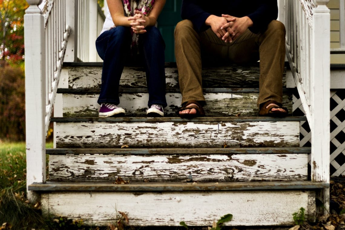 man_and_woman_sitting_on_wooden_steps