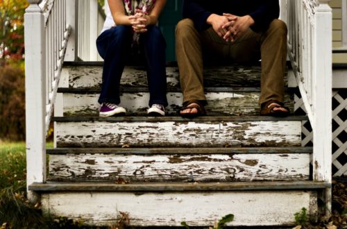 man_and_woman_sitting_on_wooden_steps