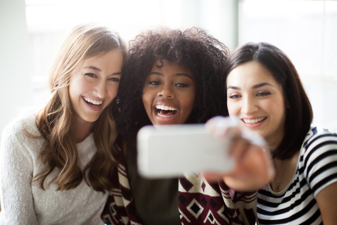 Three young women take a selfie
