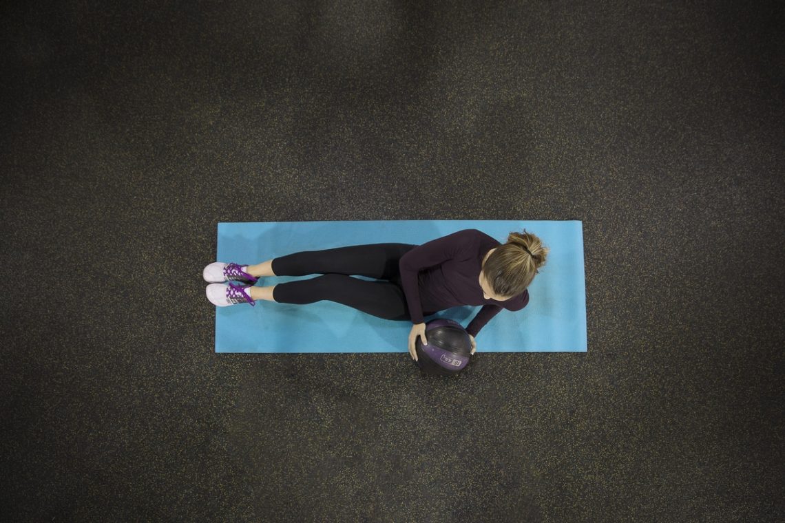 Overhead shot of woman exercising on mat