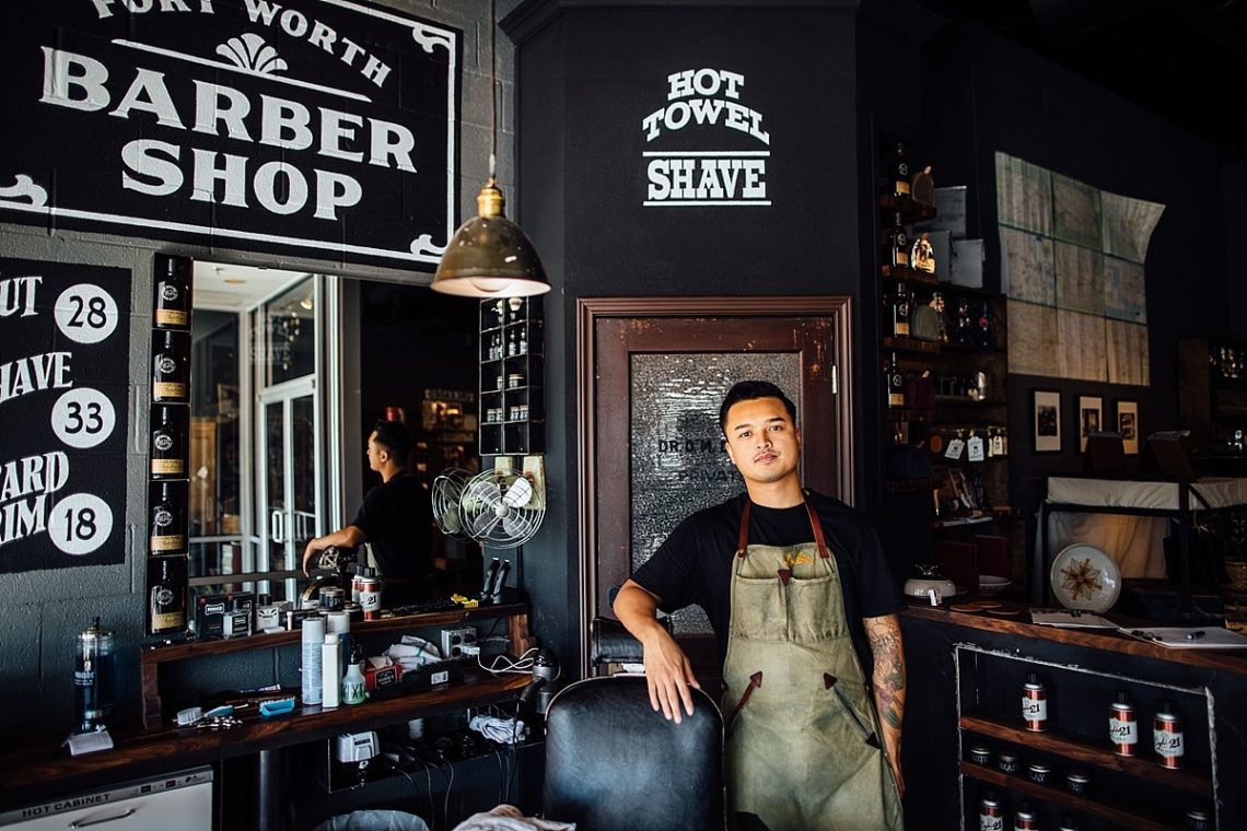 Old-style barber shop with young man leaning on chair