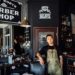 Old-style barber shop with young man leaning on chair